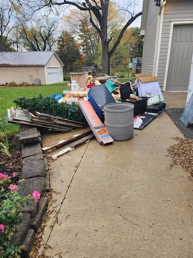 Dumpster being loaded with debris for 12 Yard Dumpster Rental in Brewton